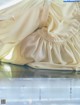 A close up of a white dress on a table.