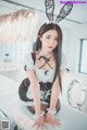 A woman in a bunny costume sitting on a table.