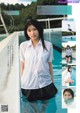 A woman in a white shirt and black skirt standing in a pool.